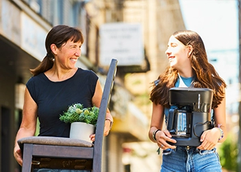 Mother and daughter moving into college dorm room
