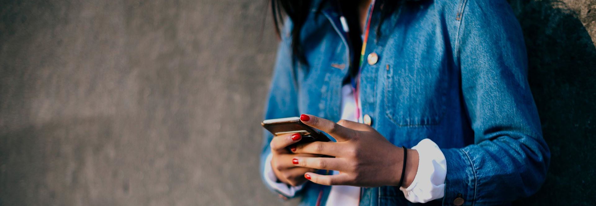 Woman uses a mobile device.