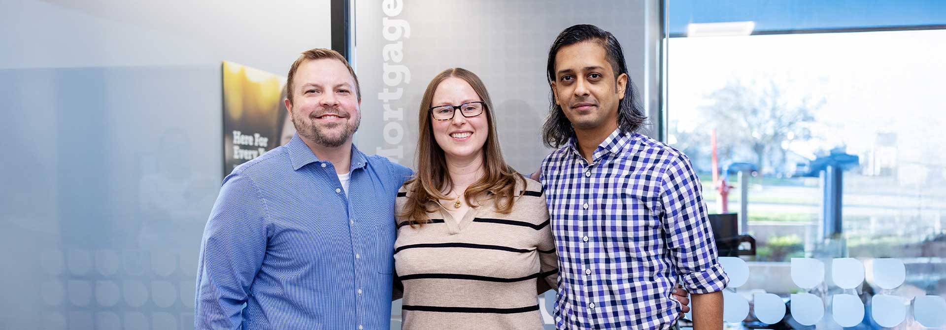 UW Credit Union Members Rachel and Shankar are pictured together with Manager of Investment Property Lending Erik Julson