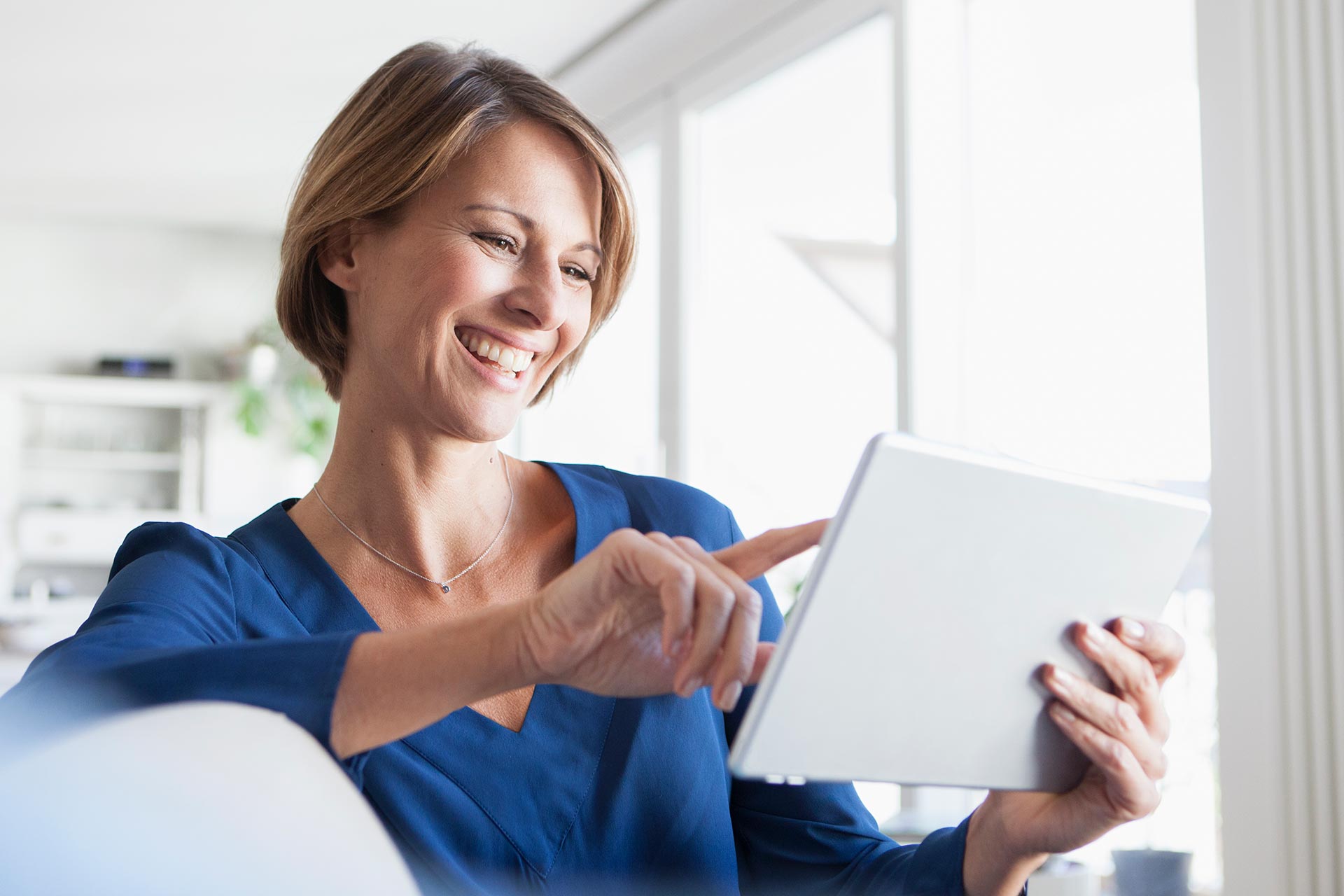 Woman researches retirement accounts on a tablet