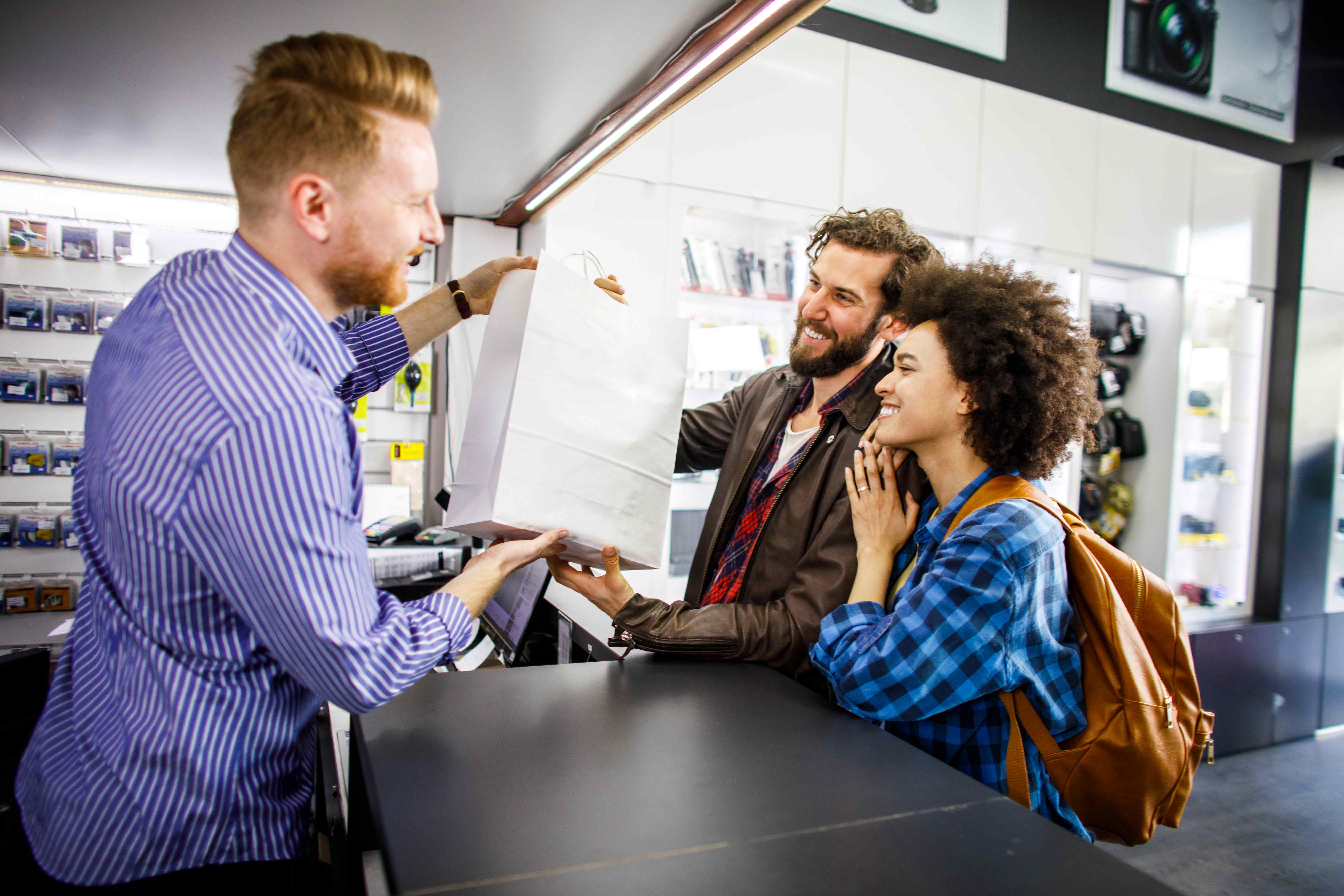 A couple makes a purchase in a retail store with a buy now, pay later transaction.