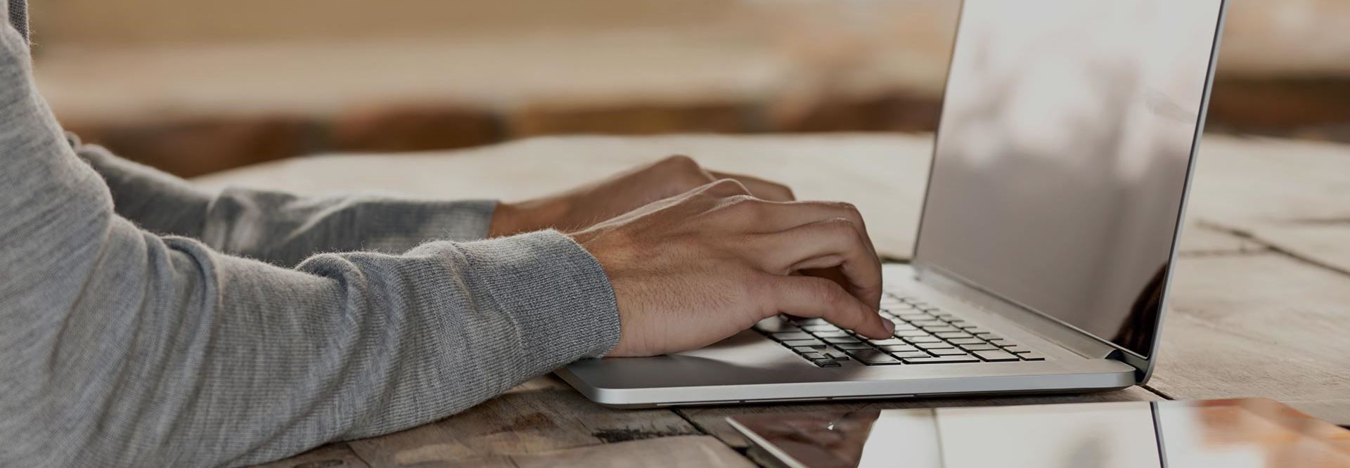 Man typing on his laptop