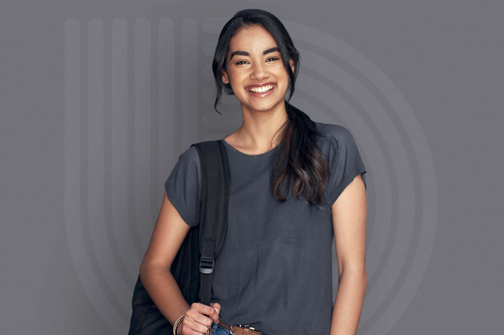 A young woman in a gray t-shirt stands in front of a gray background with the UW Credit Union Rewards Checking logo. A young woman in a gray t-shirt stands in front of a gray background with the UW Credit Union Rewards Checking logo.