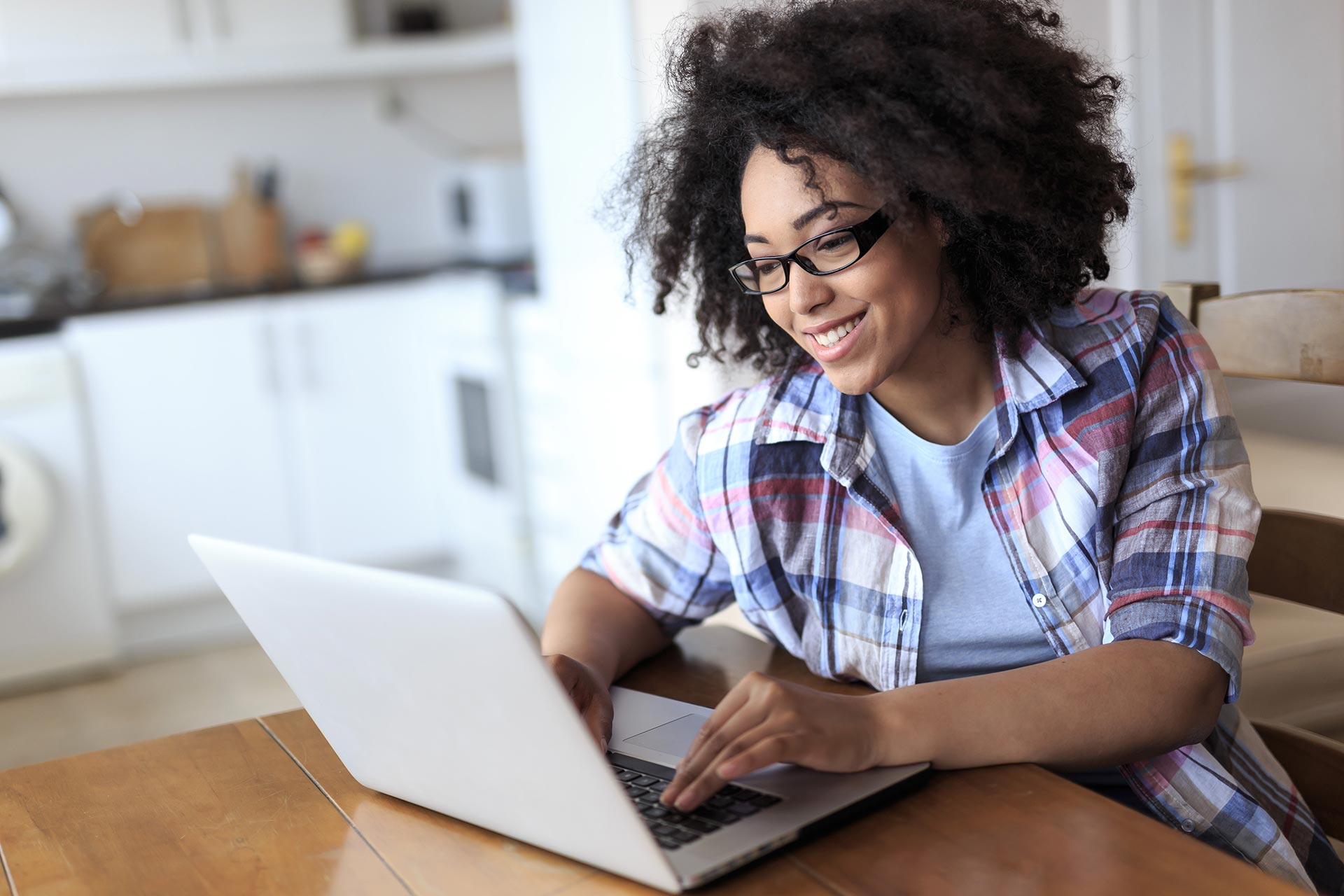 Woman uses laptop at home to review closing costs.